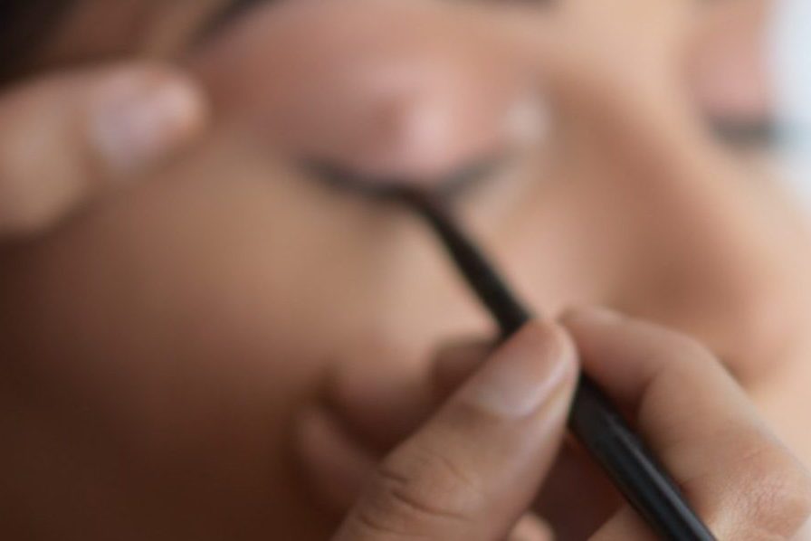 person holding black pen in close up photography