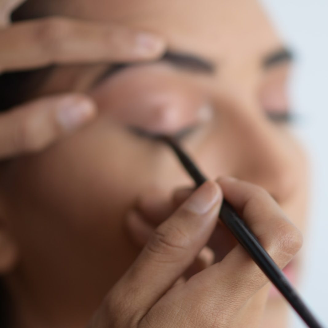 person holding black pen in close up photography