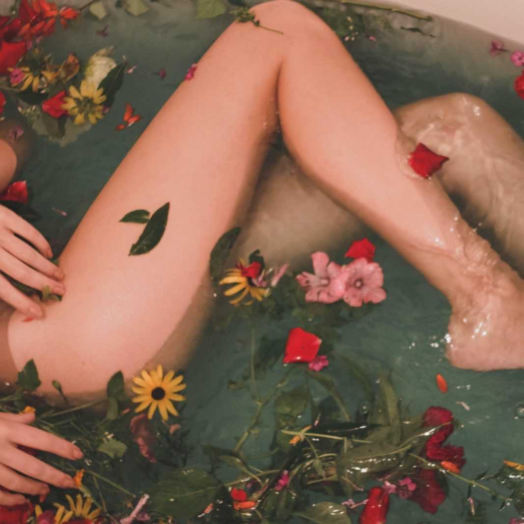 bathtub with water and flowers