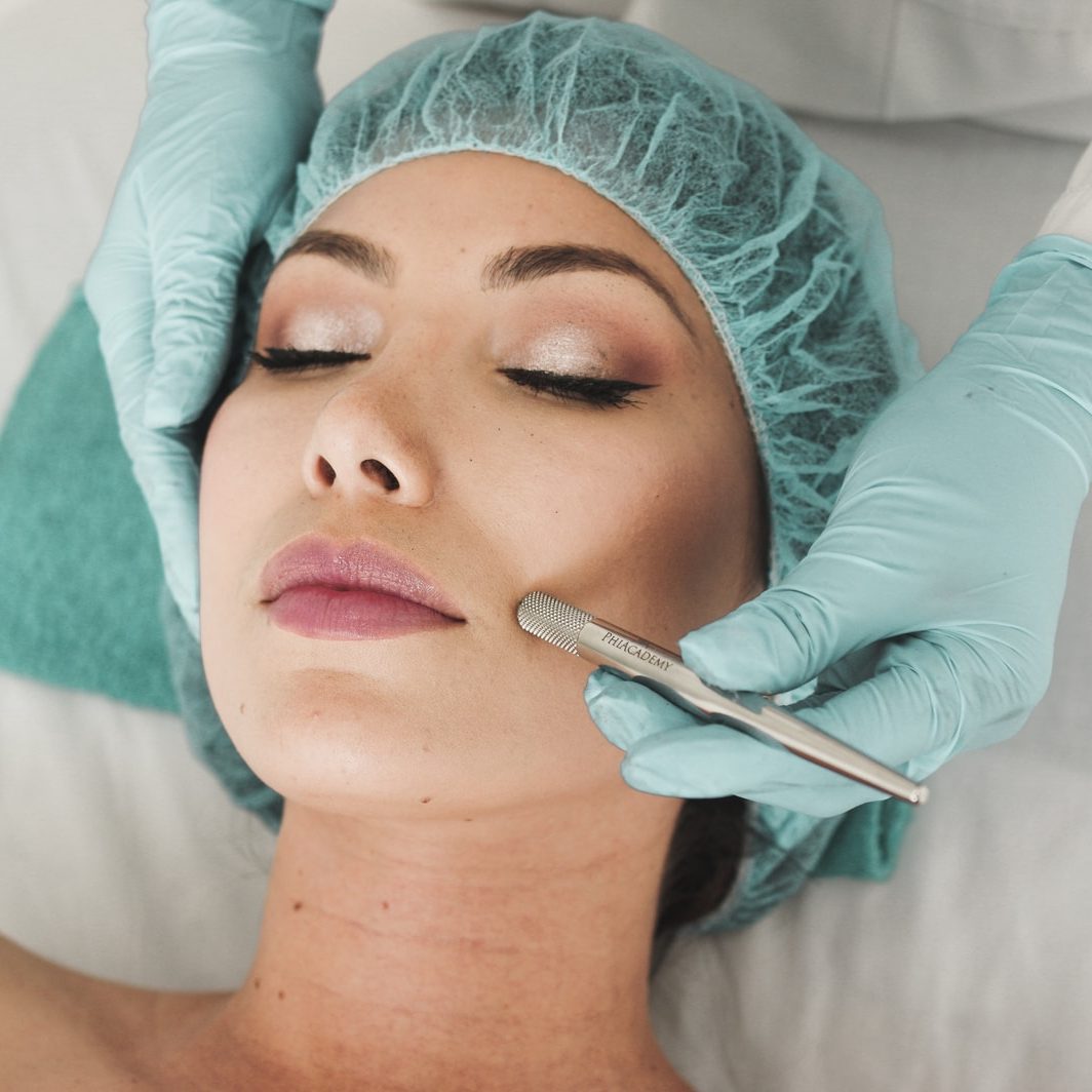 woman doing liposuction on her face